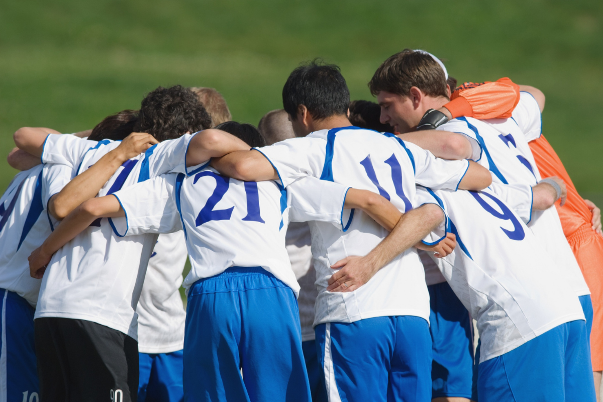 A football team huddles together before a match.